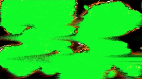 Green screen appears through burning holes on black background Stock Footage 331767898