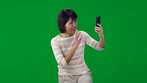 Green screen attractive middle age woman smiling enjoying talking FaceTime Stock Footage 255859305