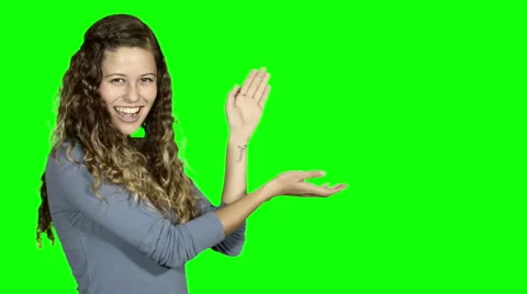 Green screen behind beautiful young presenting empty space and smiling. Stock Footage 54304720