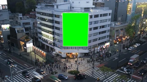 Green screen billboard on a city building, crossroad with neon lights, cyberpunk Stock Footage