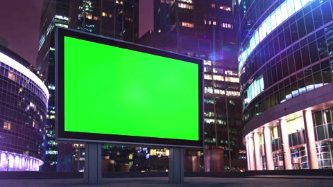 Green screen billboard displaying advertisement at night in a modern city Video stock 306745724