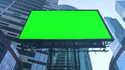 Green screen billboard hanging between skyscrapers showing empty copy space 動画素材 306747399