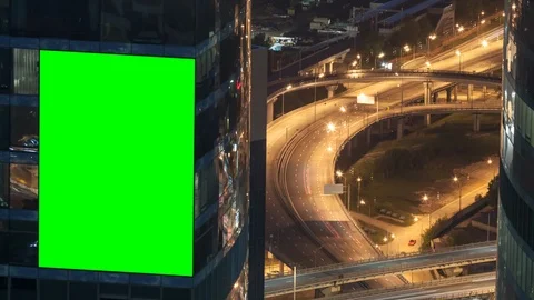 Green screen blank billboard on a skyscraper, urban interchange top view Stock Footage 117912838
