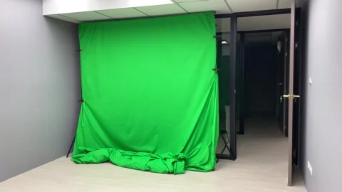 Green screen chroma key fabric canvas backdrop inside studio panning shot. Stock Footage 253533072