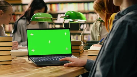 Green screen chroma key on laptop near students at group learning session Stock Footage 336361697
