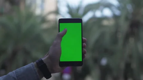 Green screen chroma key smartphone is held my male hands with smartwatch Stock Footage 134383712