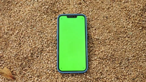 Green Screen chroma key on Smartphone phone on sand beach in Barcelona city view Stock Footage 247137860