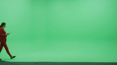 Green Screen Chroma Key Studio: Business Woman in Red Suit Use Smartphone Device Stock Footage 129392178