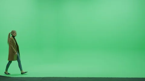 Green Screen Chroma Key Studio: Beautiful Blonde Woman Wearing Stylish Coat Walk Stock Footage 129392411