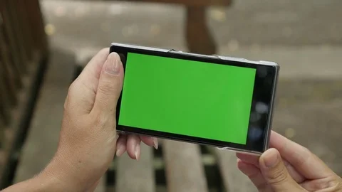 Green screen chroma key tablet in woman hands outdoor zoom out 動画素材 72214597