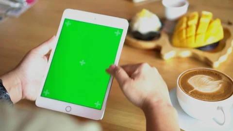 Green screen chroma key on tablet,women working or using tablet in coffee shop. Stock Footage 96381643