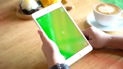 Green screen chroma key on tablet,women working or using tablet in coffee shop. Stock Footage 96381988