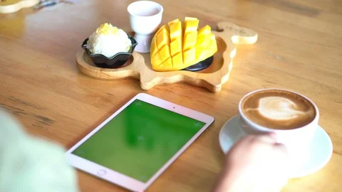 Green screen chroma key on tablet,women working or using tablet in coffee shop. Stock Footage 96384771