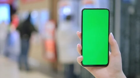 GREEN SCREEN CHROMA KEY Unrecognizable caucasian female using her phone inside Stock Footage 256977576