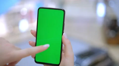 GREEN SCREEN CHROMA KEY Unrecognizable caucasian female using her phone inside Stock Footage 259201809