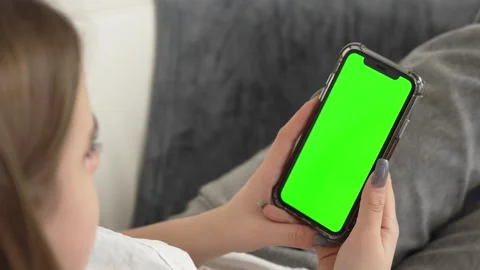 GREEN SCREEN CHROMA KEY Unrecognizable female using her phone inside her Video stock 263226413