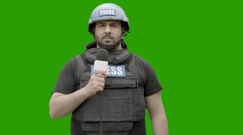GREEN SCREEN CHROMA KEY War journalist wearing protective gear reporting live Stock Photos