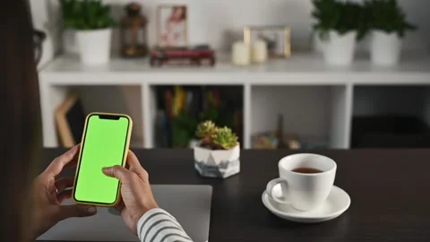Green screen Chromakey Mock-Up smartphone display. Young woman flipping through Stock Footage 220556779