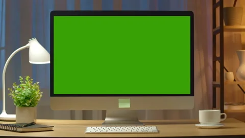 Green screen computer on a desktop in an illuminated stylish room. Business work Stock Footage 236320451