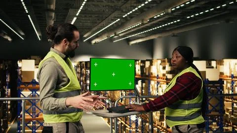 Green screen computer desktop, two workers team, distribution center Stock Photos