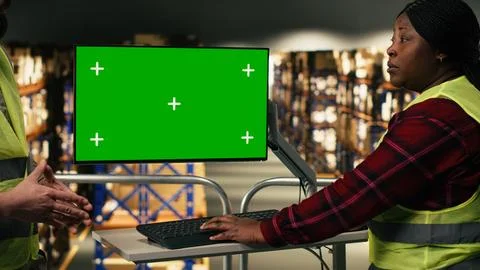 Green screen computer desktop, two workers team, distribution center Stock Photos