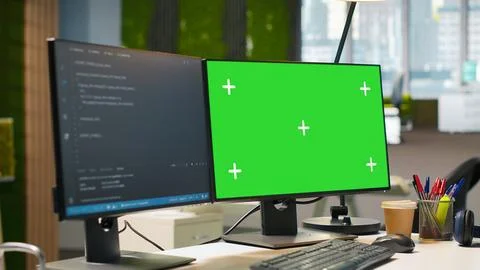 Green screen computer display in modern startup office displaying code snippets Stock Photos