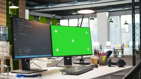 Green screen computer display in modern startup office displaying code snippets Stock Photos