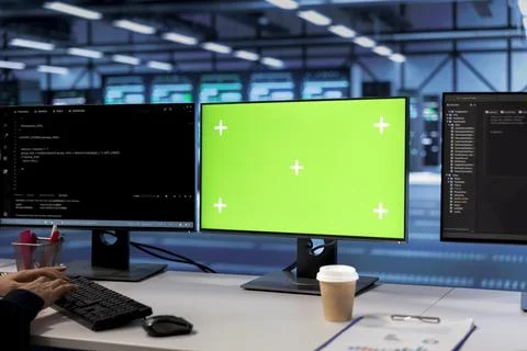 Green screen computers in data center facility managing servers Foto stock
