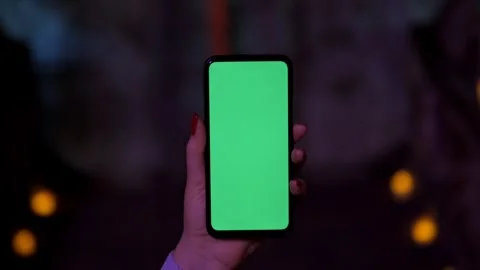 A Green Screen displayed on a handheld Smartphone, showcasing modern technology Stock Footage 280988220
