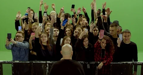 GREEN SCREEN Front view huge crowd of people with phones in hands at live Stock Footage 125628241