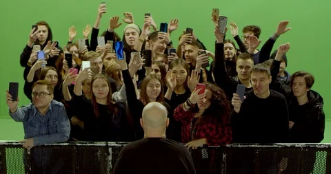 GREEN SCREEN Front view huge crowd of people with phones in hands at live Stock Footage 125628683