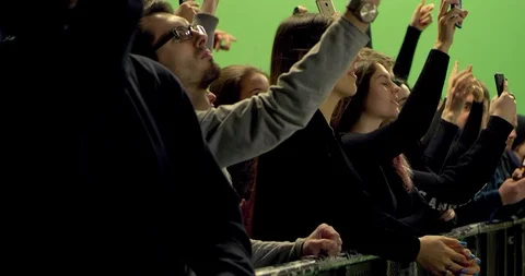 GREEN SCREEN Front view huge crowd dancing and cheering behind control barrier Stock Footage 125633717