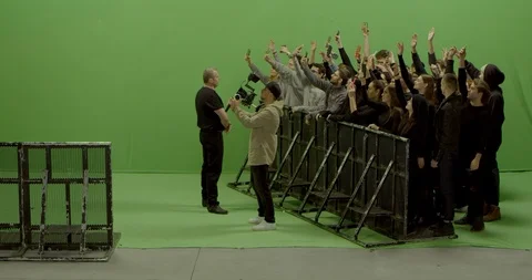 GREEN SCREEN Front view huge crowd dancing and cheering behind control barrier Stock Footage 125637198
