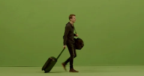 GREEN SCREEN FULL SHOT Caucasian male walking with suitcases in the airport Stock Footage 126096812