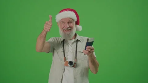 Green Screen. Happy Old Man Tourist in Santa Hat Shows Thumb Up. Stock Footage 243469213