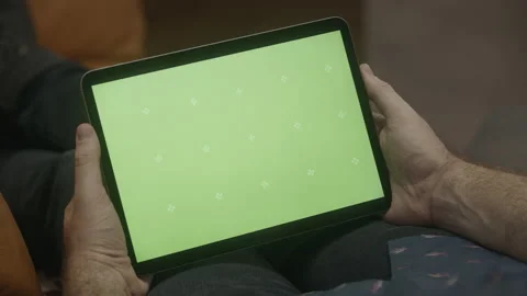 Green screen iPad in Man's hand on couch  (1 of 3) Stock Footage 195333960
