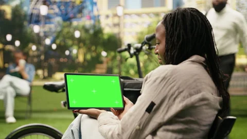 Green screen isolated mockup on tablet held by delivery courier in city park Stock Footage 343500984