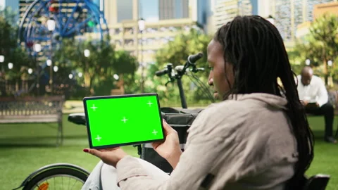 Green screen isolated mockup on tablet held by delivery courier in city park Stock Footage 343507324