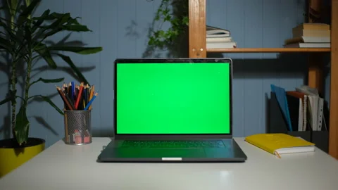 Green screen laptop computer on a homework desk. Video stock 148678363