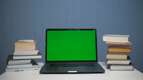 Green screen laptop computer sitting on a homework desk with books. Stock Footage 148678484