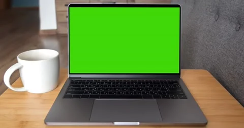 Green screen laptop computer sitting on a home work Video stock 148898614