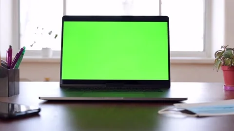 Green screen laptop computer sitting on a home work desk. Stock Footage 149042154