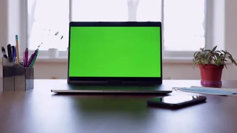 Green screen laptop computer sitting on a home work desk. Stock Footage 149042185