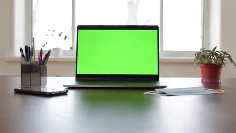 Green screen laptop computer sitting on a home work desk. Stock Footage 149042723