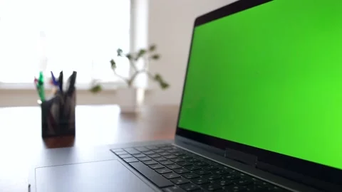 Green screen laptop computer sitting on a home work desk. Stock Footage 149042804