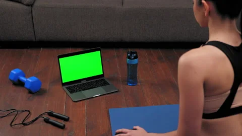 Green screen laptop concept: Athletic woman in sportswear sits on yoga mat Stock Footage 152138660