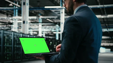 Green screen laptop, debugging system errors and technician in data center Stock Footage 329591132