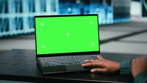 Green screen laptop, debugging system errors and technician in data center Stock Footage 329720602
