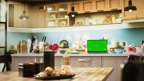 Green screen laptop in empty kitchen with island and modern appliances Stock Footage 320722879