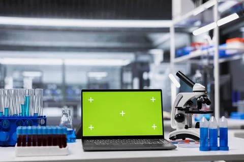 Green screen laptop on empty laboratory desk Stock Photos